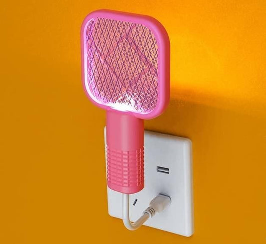 Pink electronic device plugged into a wall socket on an orange background